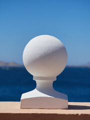 Decorative white sphere with beautiful sea and blue sky in the background