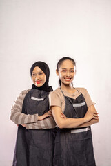 Two Asian barista  woman standing with crossed hand isolated on white background