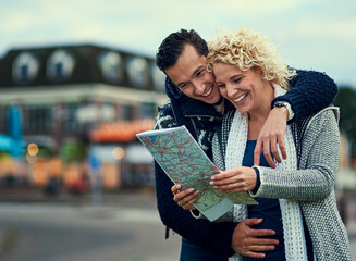 Happy, couple and tourists with map in outdoor for location, direction and travel on vacation for...