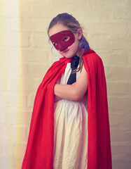 Children, costume and girl with arms crossed superhero cape and mask on for fantasy, learning or...