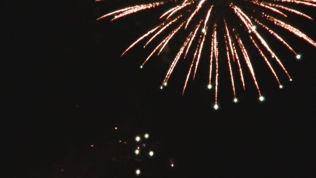 Colorful fireworks shots on black sky background - festive abstract natural background in real time. Topics: celebration, festival, holidays, free time, joy, show, jubilee
