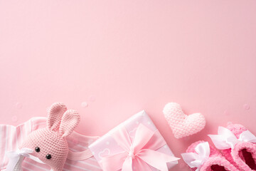 Pink baby gifts and accessories including knitted toy, heart, and baby shoes on a soft pastel background, perfect for baby shower or gender reveal party