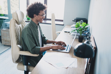 Photo of happy positive broker wear khaki shirt spectacles communicating modern device indoors...