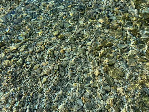 Pebbles stones in transparent sea water
