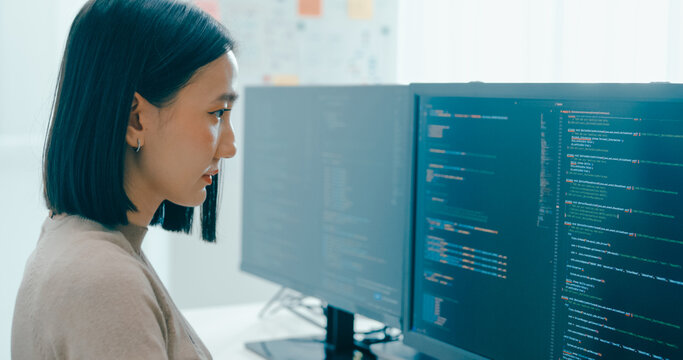 Young adult Asia female freelance typing write prompt AI bot IT app smart program nomad, video game, terminal with coding language, user interface, designer, big data center on desktop computer.