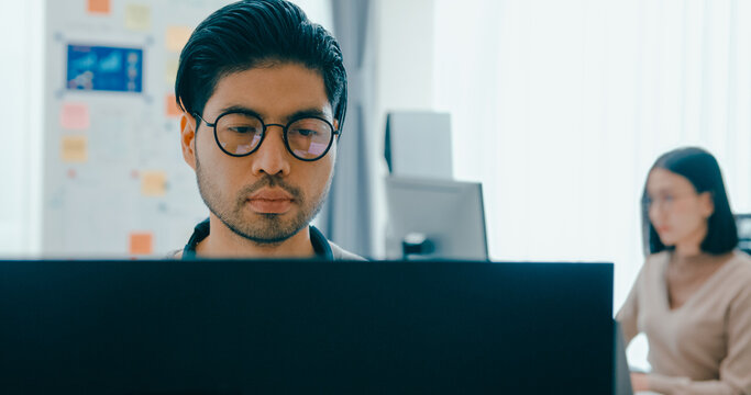 Group Adult Asia male, female freelance typing write prompt AI bot IT app smart program nomad, video game, terminal with coding language, user interface, designer, big data center on desktop computer.