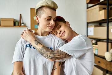 lesbian couple with tattoos on arms embracing each other warmly.