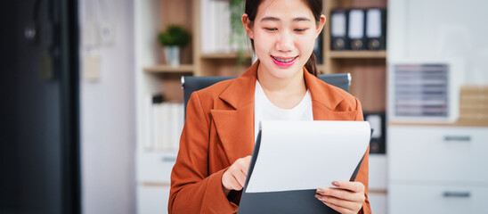 Asian businesswoman specializing in stock market and financial services, including roles as a loan...