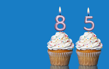 Birthday Cupcakes With Candles Lit Forming The Number 85