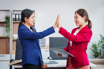 Two successful Asian businesswomen collaborate, discussing comments and suggestions on various financial matters, including the stock market, loans, securities law, and investment strategies.