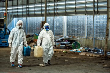 Male inspector team investigate danger chemical gas leak spill with safety face mask PPE suit in area closed barricade security tape. danger dirty area infected chemical leak spill cross stripe ribbon