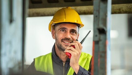 male maintenance engineer in uniform helmet safety talk by walki talkie and inspection check...