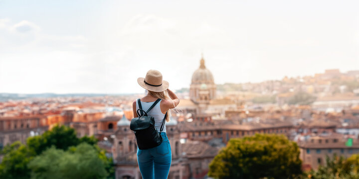 Young attractive smiling girl tourist exploring new city at summer
