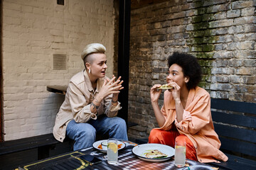 Two women enjoying a meal at a table in a cafe.