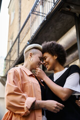 Diverse lesbian couple standing together in a cafe.