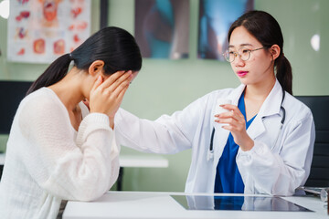 Asian female doctor specializing in psychiatry online consultations from desk, psychotherapy,...