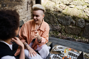A serene moment captured with two women sitting together on a bench.