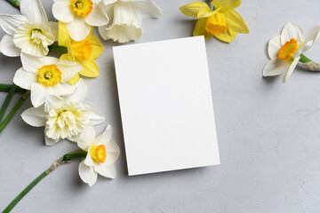 White square wedding invitation, flyer or greeting card mockup with yellow daffodils flowers, blank...