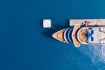 Cruise liner ship moored on the pier, cruise sea vacation. Aerial top down view