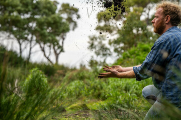 regenerative organic farmer, taking soil samples and looking at plant growth in a farm. practicing...