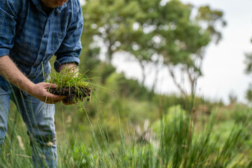 farmer holding soil looking at soil carbon in the america