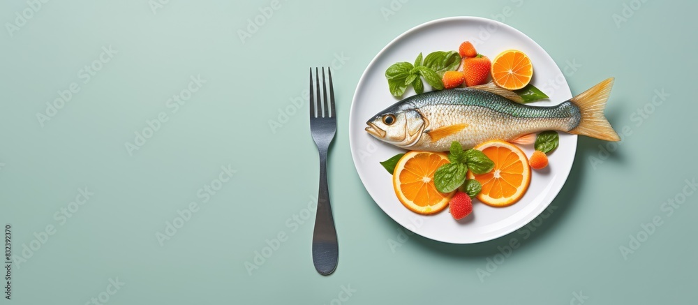 Poster Leafy salad with red fried fish and orange on a white plate with a fork on a grey background Background image copy space