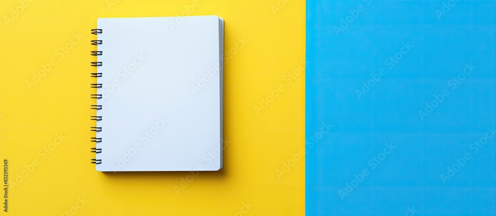 Aufkleber flat lay design with blank on note book yellow and blue background. copy space available