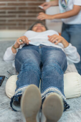 Fototapeta premium Woman lying on the couch waiting for acupuncture treatment. Vertical