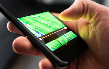 Watching sport stream with phone. Football or soccer live on tv. Game and match video in...