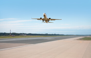 White Passenger plane fly up over take-off runway from airport - Barcelona, Spain