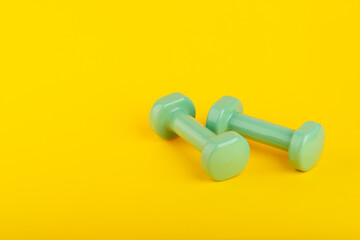 Gym equipment on yellow background. Space for text