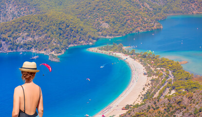 Blue Lagoon in Oludeniz - Young fashion girl relax on the beach of sea - Oludeniz, Fethiye