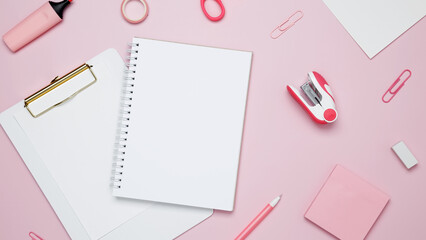 Creative flat lay mockup design of workspace. Top view composition with white notebook, to do list and stationery on pink background