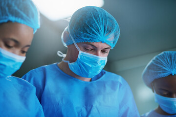 Team of doctors in surgery, healthcare and surgical procedure start with PPE and group in theatre...