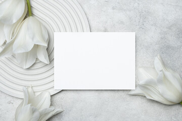 White wedding invitation card mockup with tulips flowers, copy space for card design, blank card...