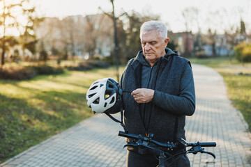 Man Standing Next to Bike With Helmet On