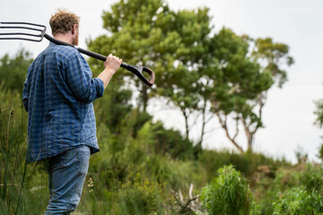 regenerative organic farmer, taking soil samples and looking at plant growth in a farm. practicing sustainable agriculture.