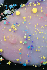 A myriad of oil droplets intermingling with water, creating a mesmerizing effect reminiscent of a galaxy.