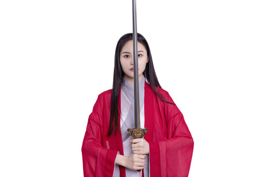 An oriental beauty in a red costume holds a sword
