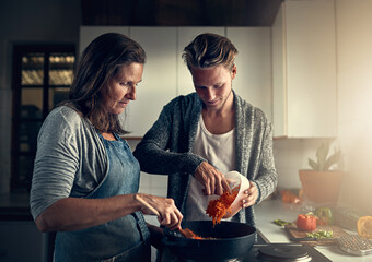 Mature, mother and son with vegetables in kitchen for bonding, support or helping with cooking for...