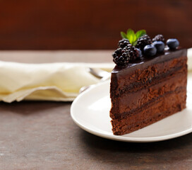piece of chocolate cake with cream and berries