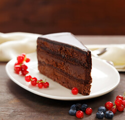 piece of chocolate cake with cream and berries