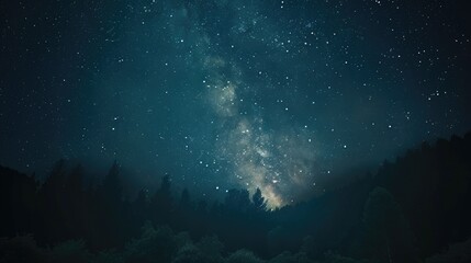 Obraz premium A peaceful night sky with a visible Milky Way and countless stars, creating a sense of awe and wonder