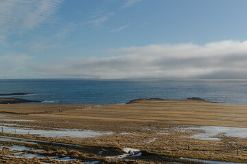 Coastal view with a clear blue sky and calm ocean Iceland no people outside