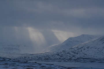 Blue sky peeking through dark storm clouds