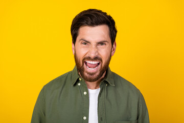 Photo of nice young man scream wear khaki shirt isolated on yellow color background