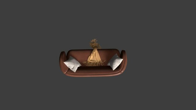 A couch with a brown blanket on it and two pillows. The couch is on a dark background