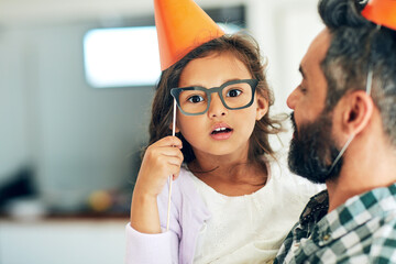 Father, daughter and portrait with birthday hats for celebration with glasses, surprised and props for decoration in home. Family, girl and dad at party event with mockup space at social gathering