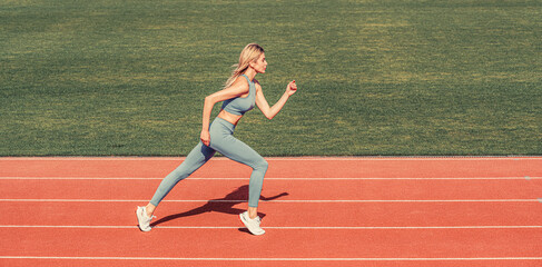 Female jogger runner running outdoors, runner. Fitness woman on stadium. Young fitness woman runner...