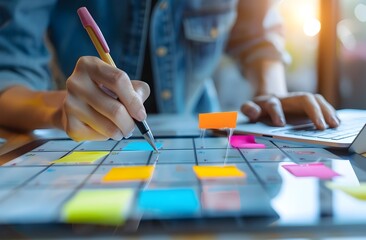 Person Using Digital Tablet to Highlight Calendar with Sticky Notes for Project Management or Vacation Planning